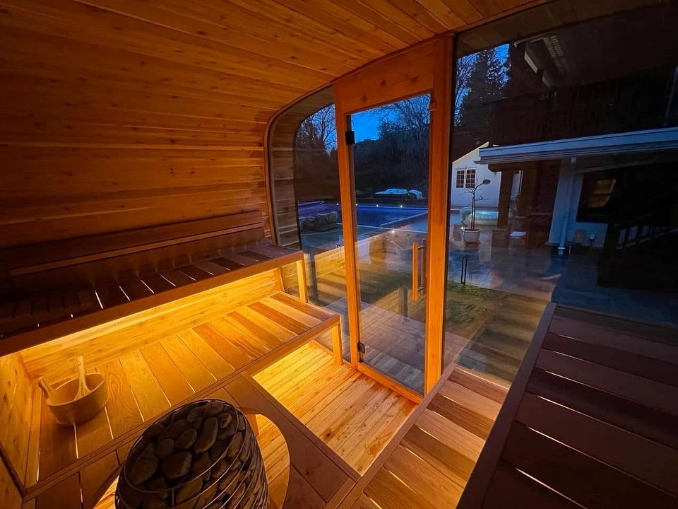 Warm western red cedar sauna interior with expansive glazing